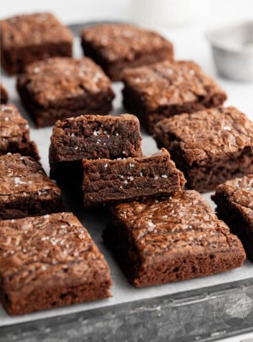 Brownies cut into squares with some stacked on top of the others.