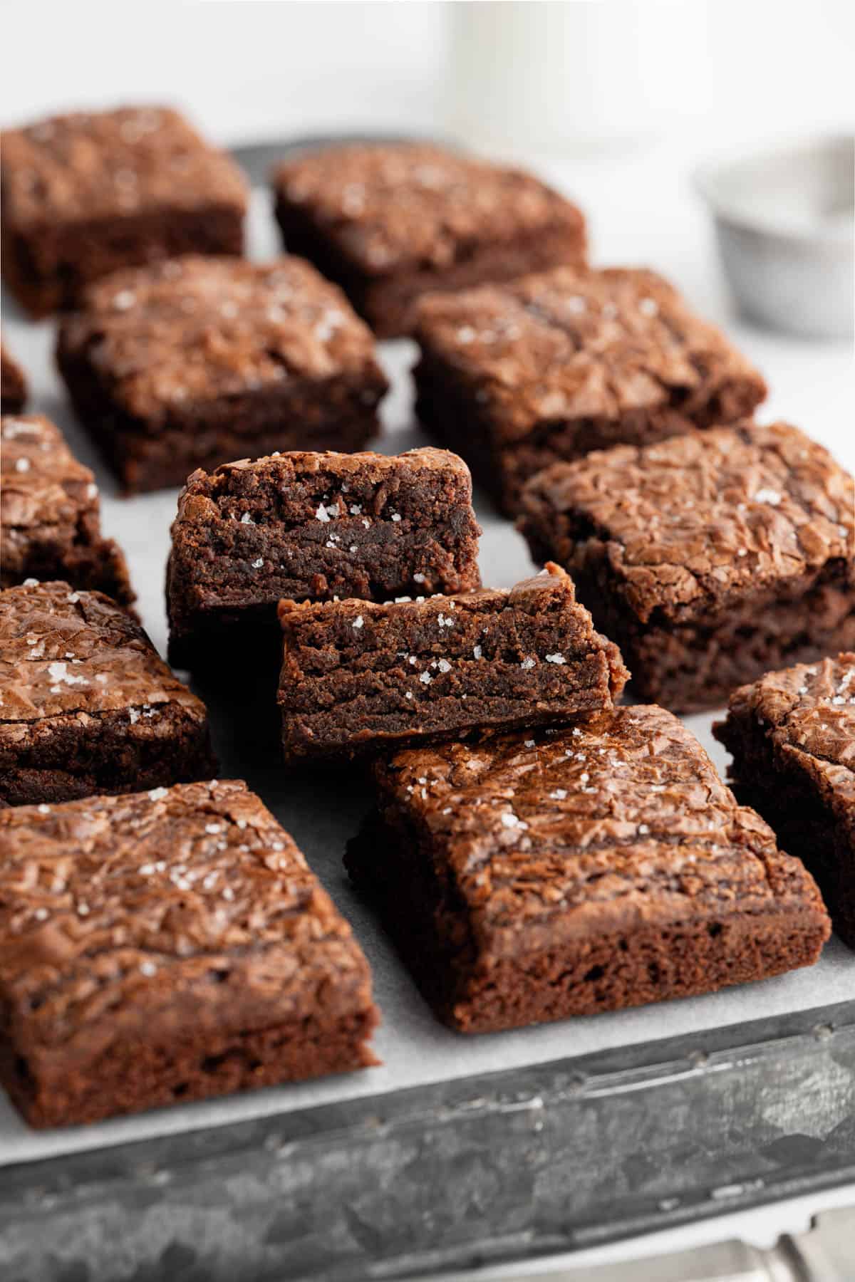 Brownies cut into squares with some stacked on top of the others.