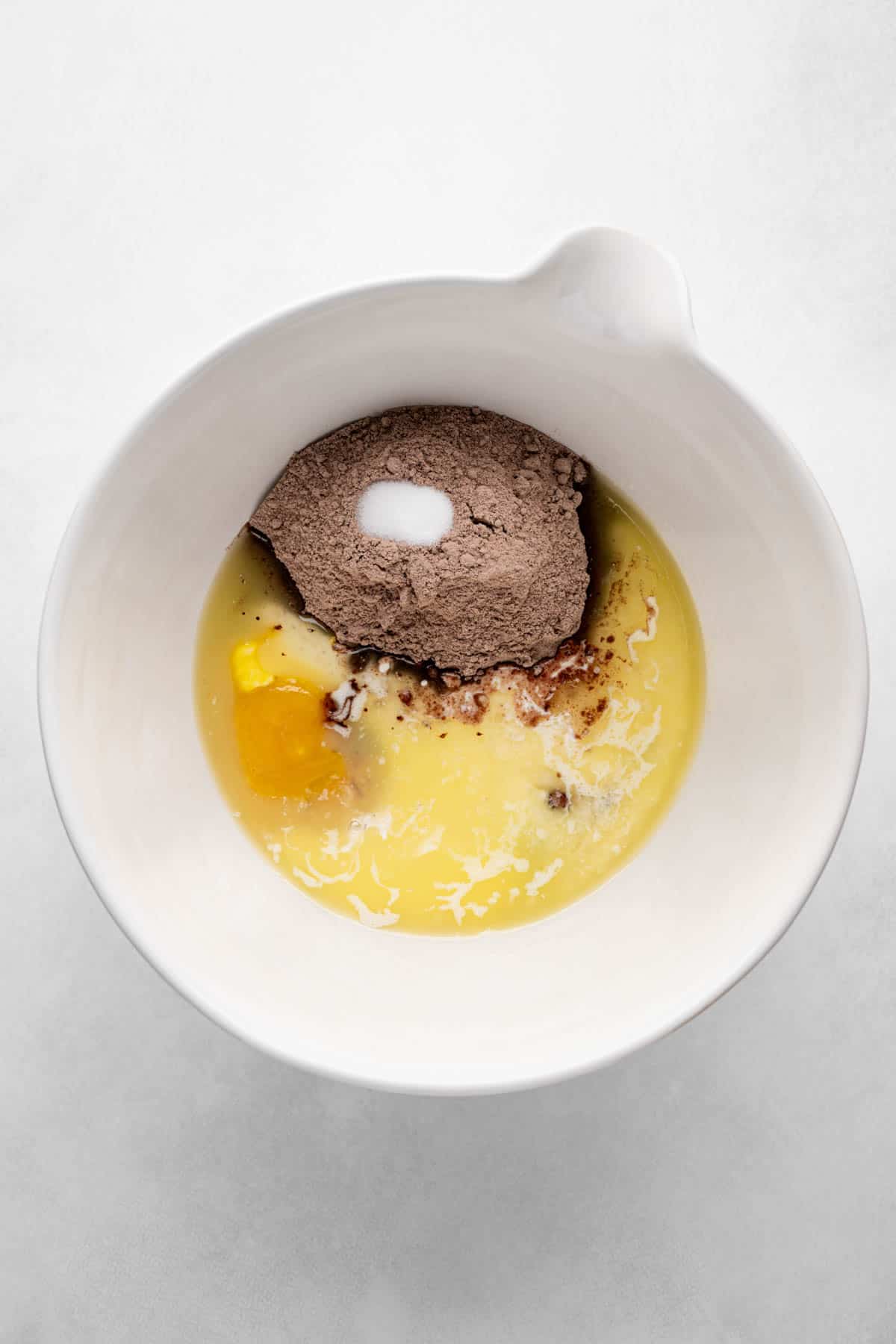 Adding brownie mix and other ingredients to a large bowl.