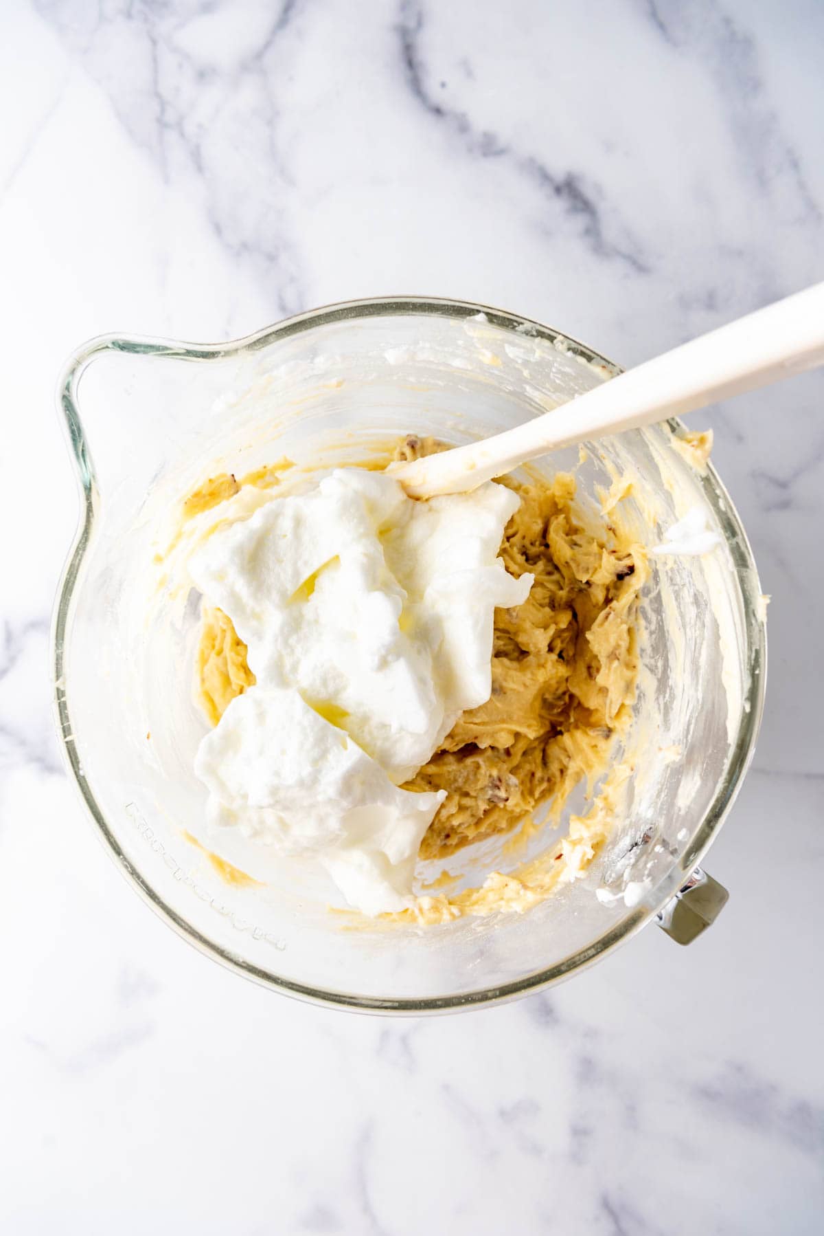 Folding stiff egg whites into cake batter.