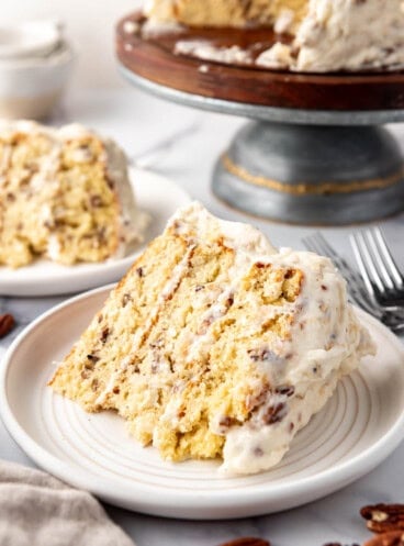 A slice of Italian cream cake on a white plate.