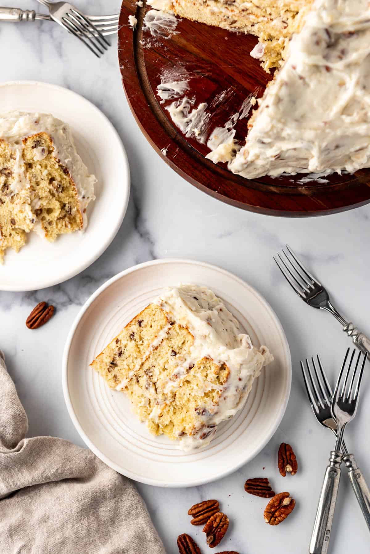 An overhead image of slices of Italian cream cake on white plates.