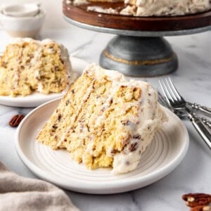 A slice of Italian cream cake on a white plate.