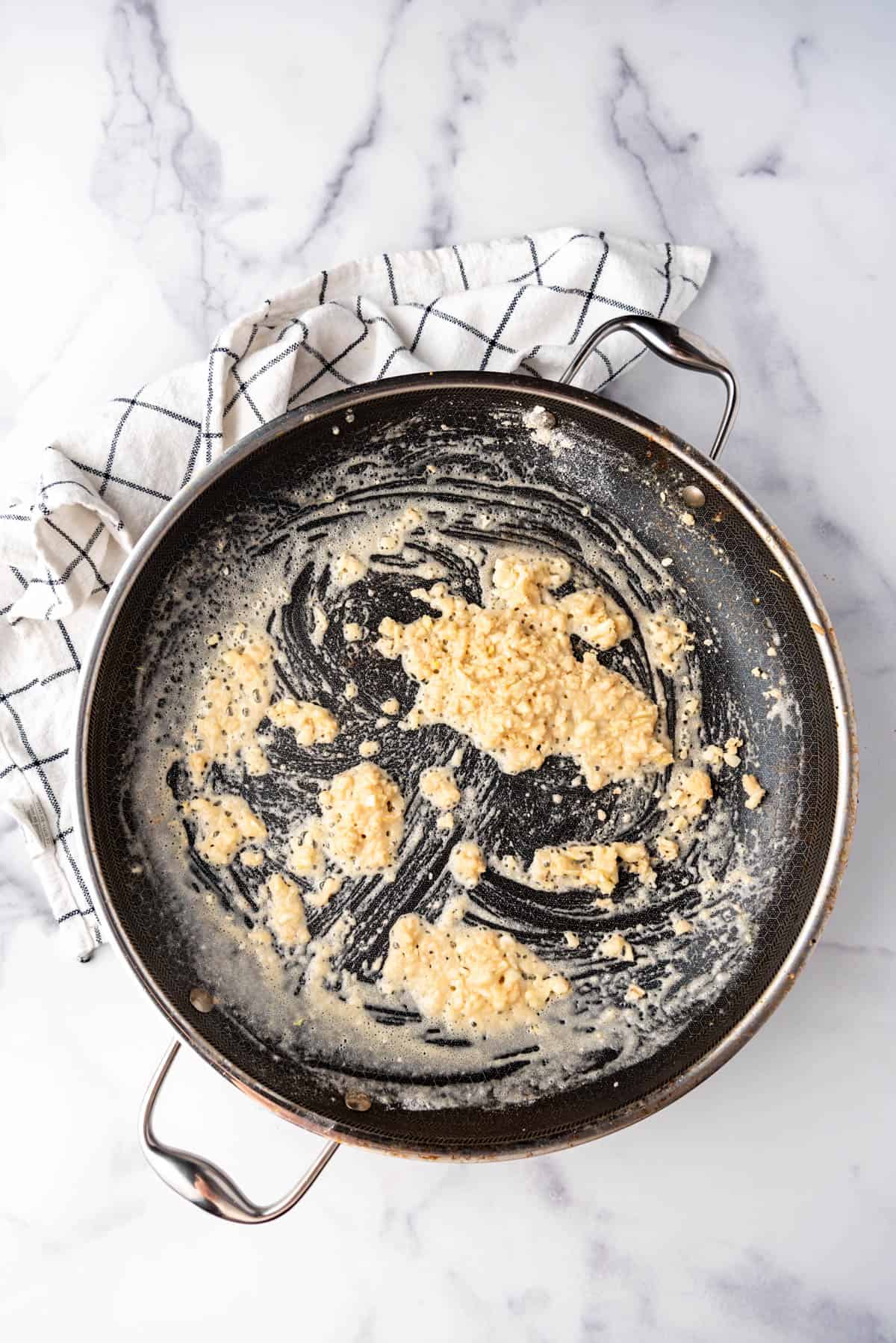 Melted butter, flour, and garlic in a large skillet.