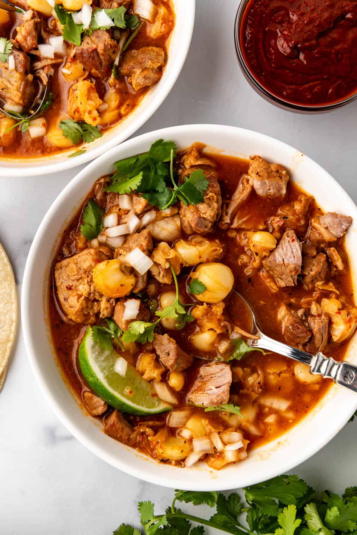 An overhead image of a bowl of New Mexico posole.