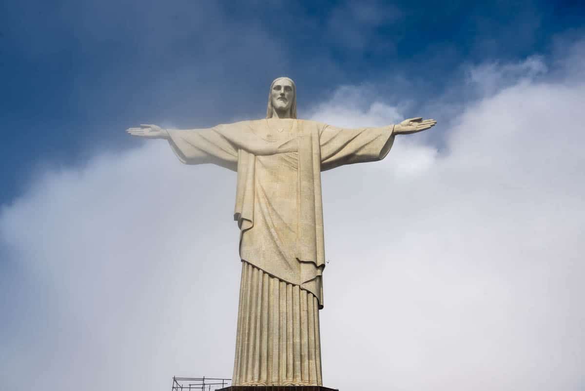 An image of the famous Christ the Redeemer Statue with clouds behind it.