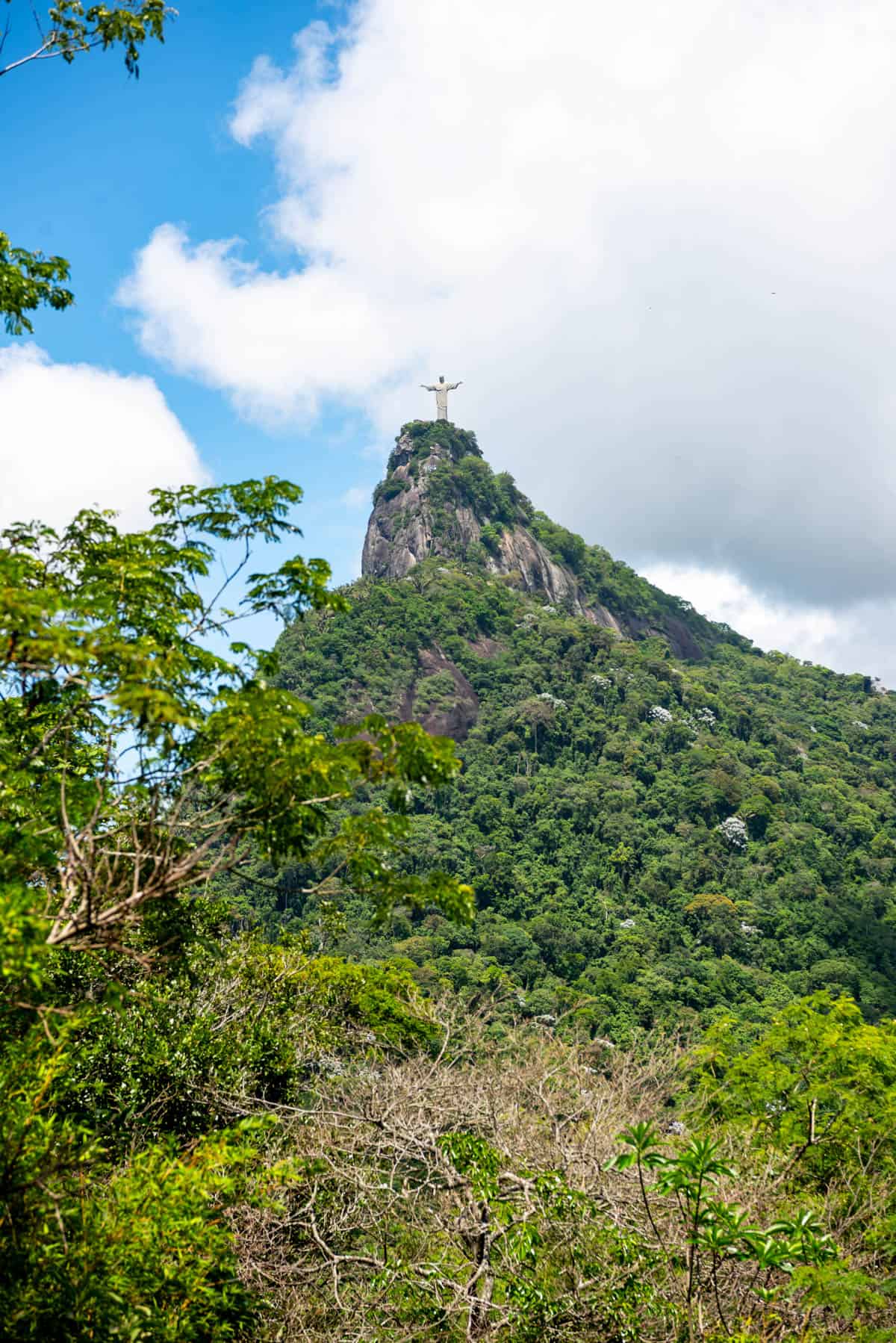 A view of Christ the Redeemer statue at the top of a mountain.