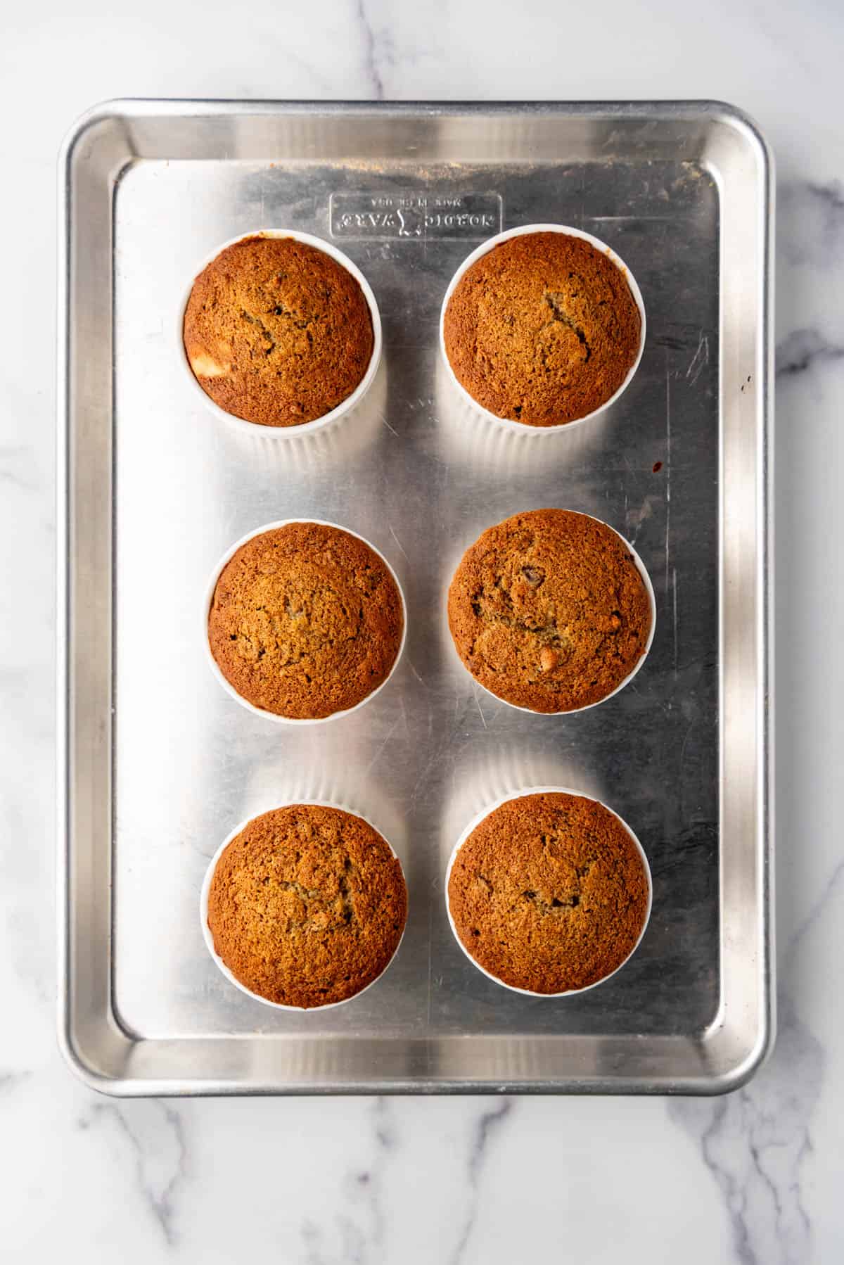 Baked sticky toffee puddings in individual ramekins.