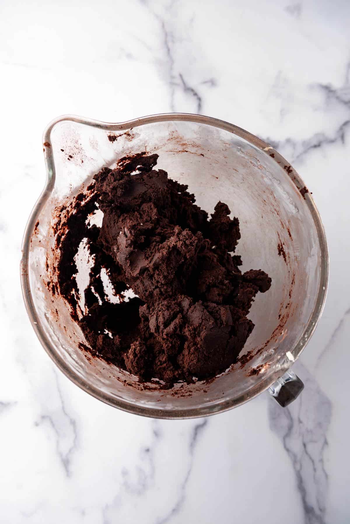 Chocolate cookie dough in a large mixing bowl.