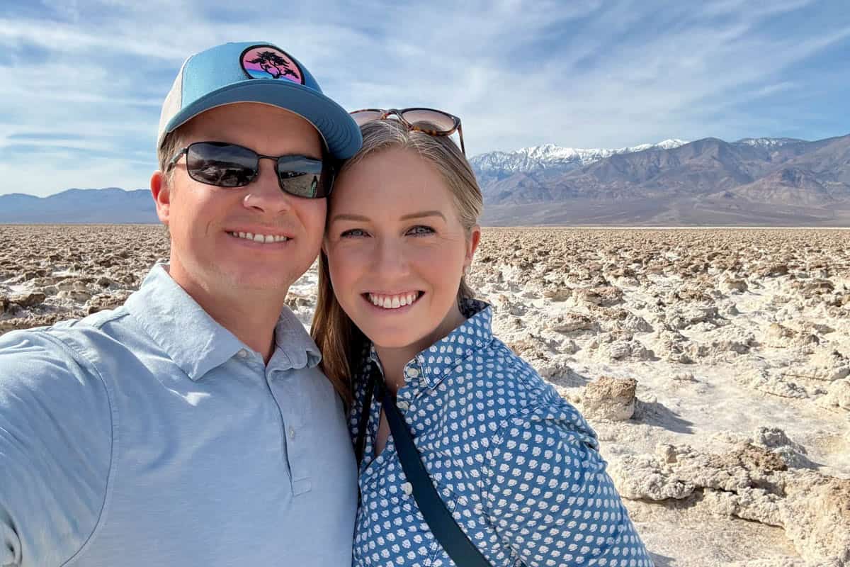 An image of a couple on the salt flats in Death Valley.