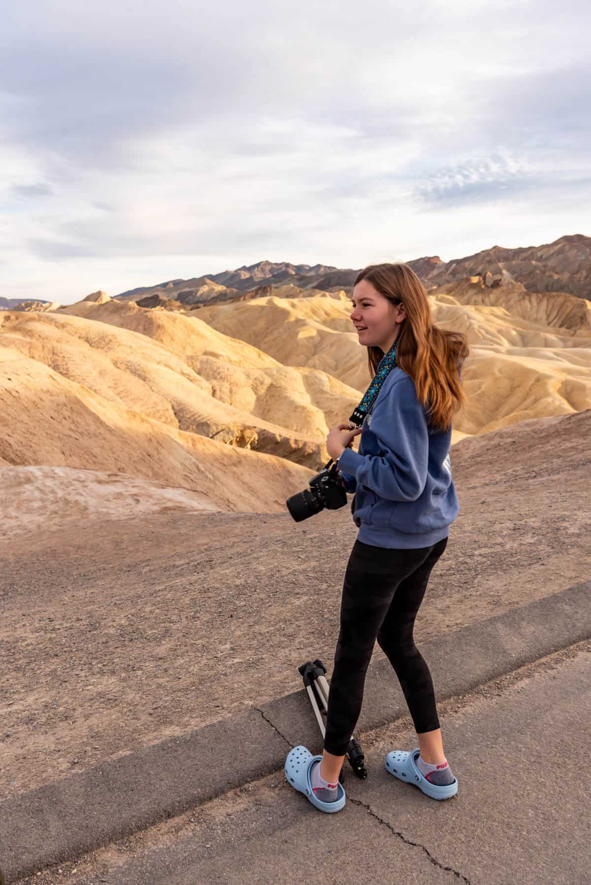 A girl holding a camera in Death Valley.