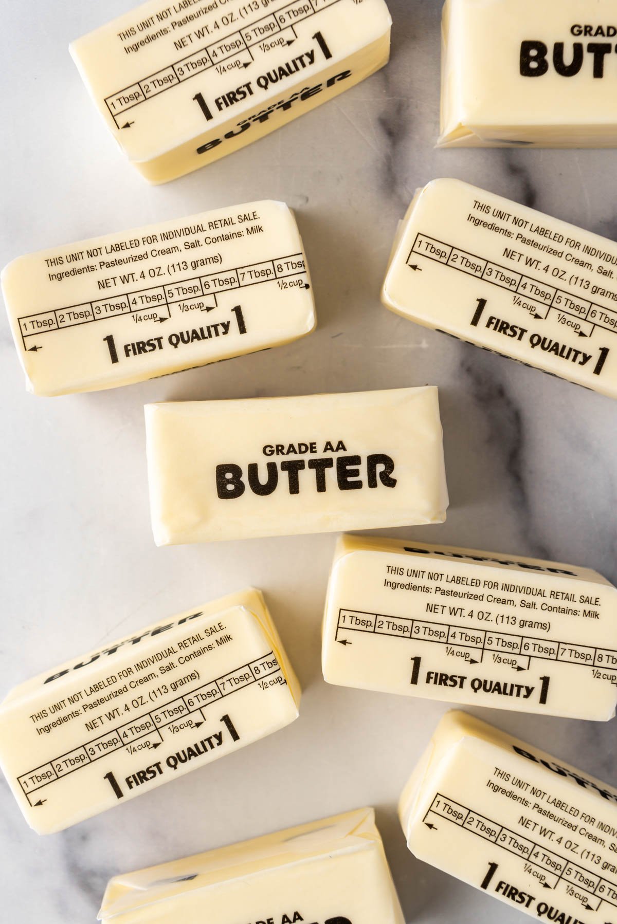 An overhead image of sticks of butter in their wrappers.