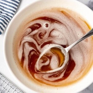 An overhead image of a bowl of brown butter with a spoon in it.