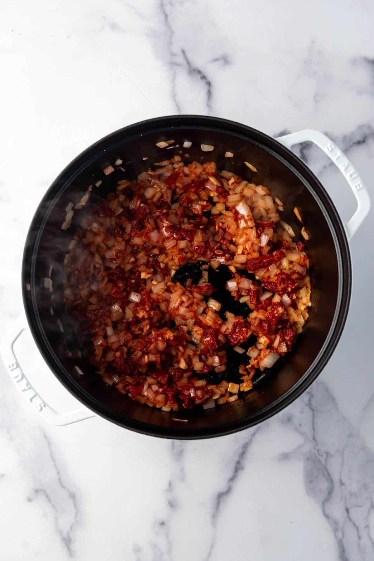 Sauteed onions, garlic, and tomato paste in a large dutch oven.