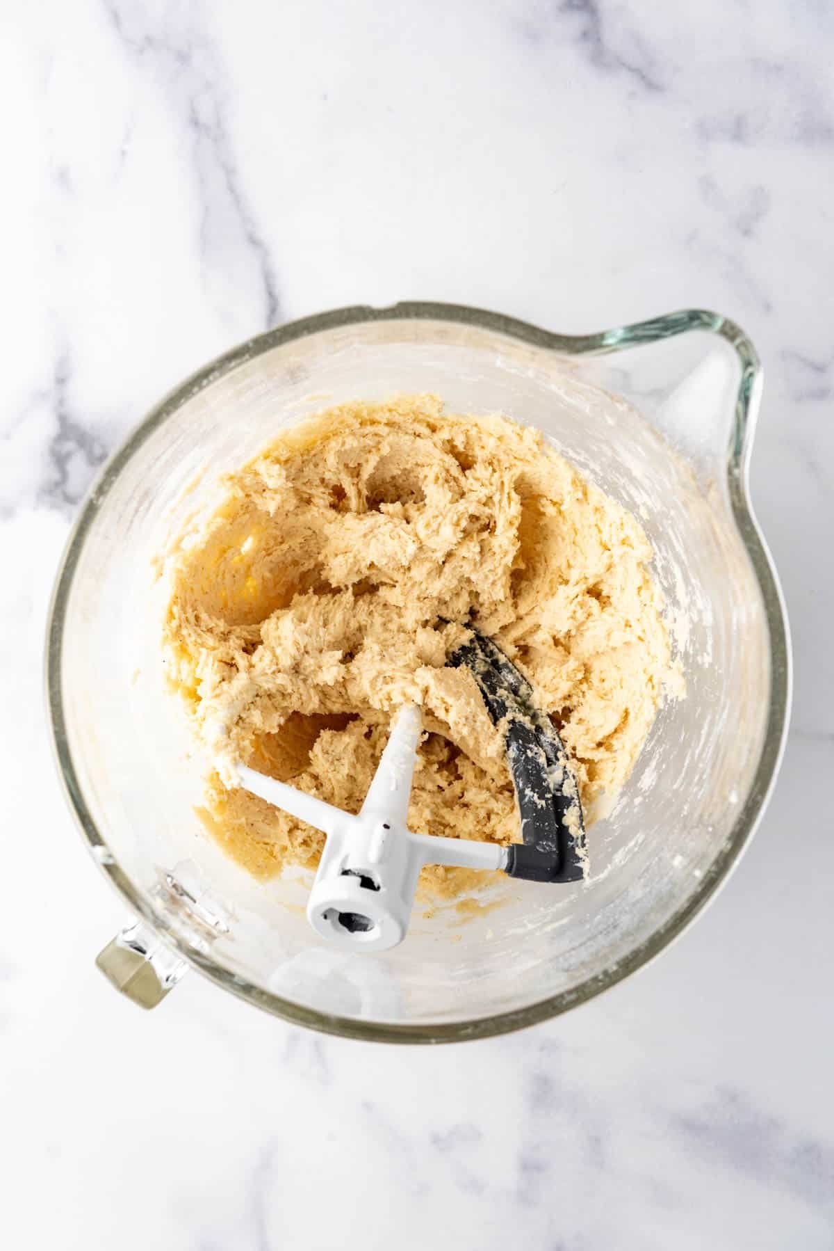 Sour cream doughnut dough in a large mixing bowl.