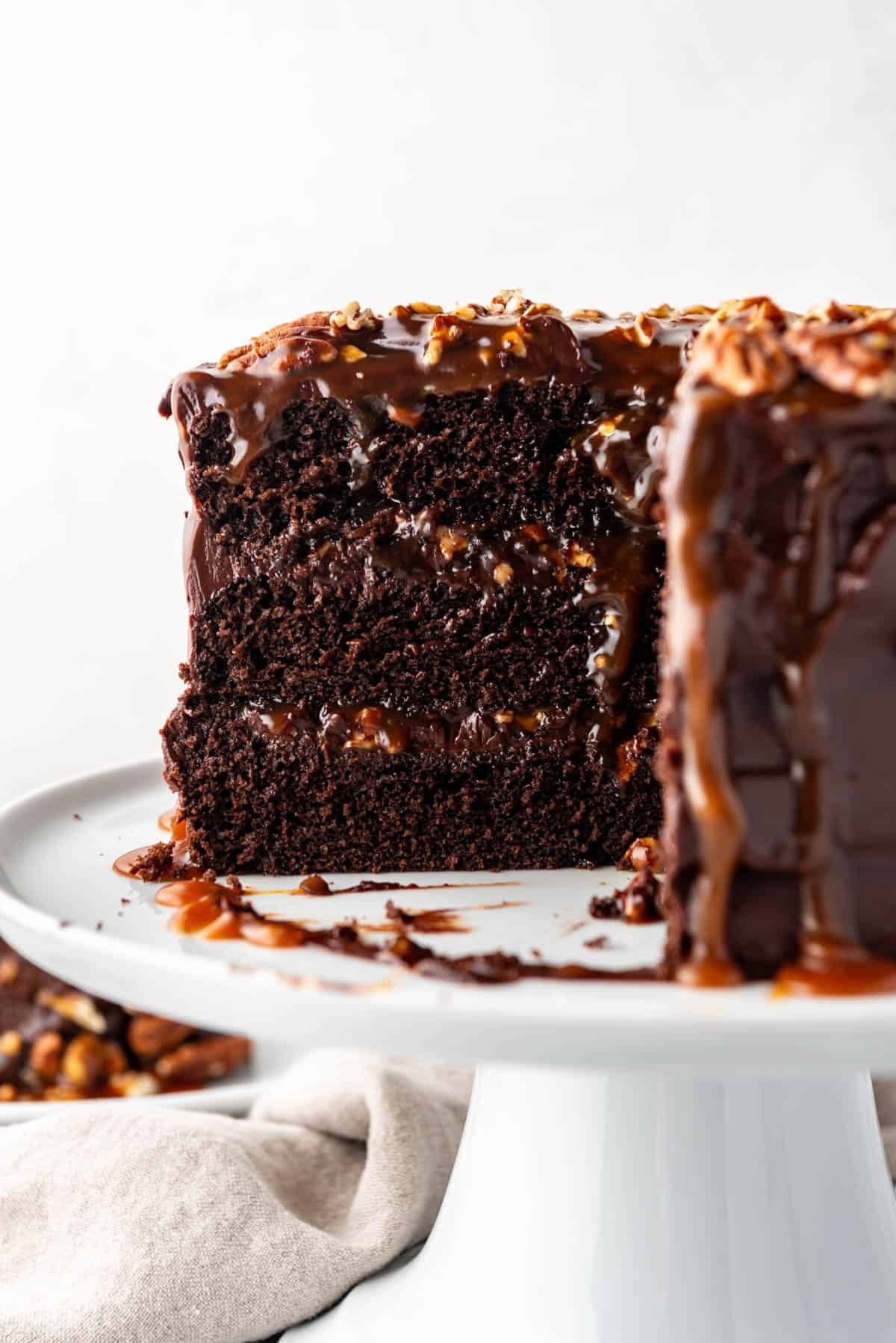 A cross-section of a chocolate caramel turtle cake.