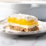 A slice of lemon lush on a white plate.