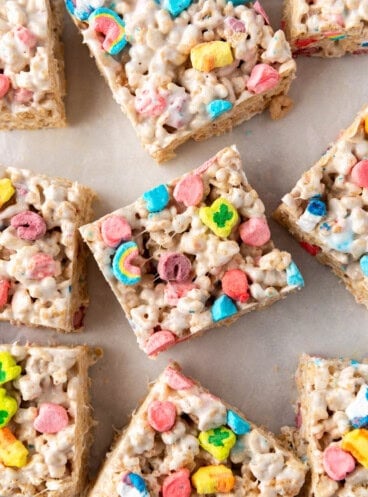 A close overhead image of a rice krispies treat with Lucky Charms marshmallow pieces on top.