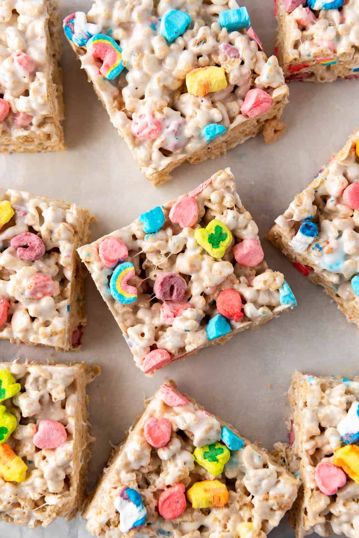 A close overhead image of a rice krispies treat with Lucky Charms marshmallow pieces on top.