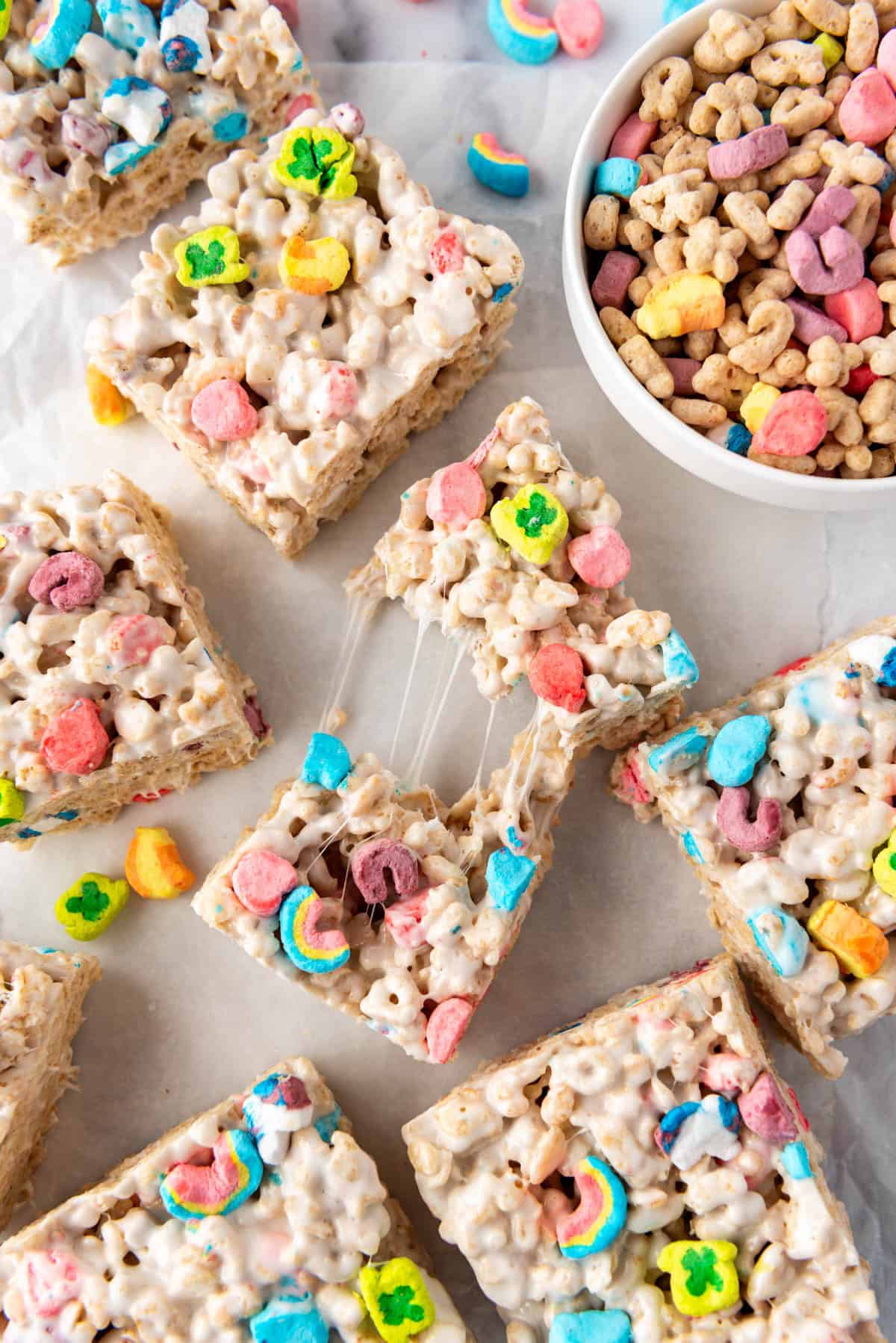 A rice krispies treat made with lucky charms that has been stretched apart.