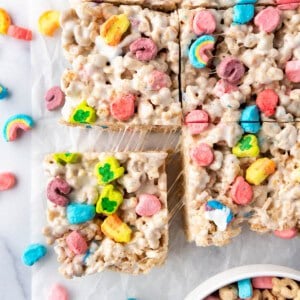 An overhead image of Lucky Charms rice krispies treats that have been cut into squares with one being pulled away from the others.