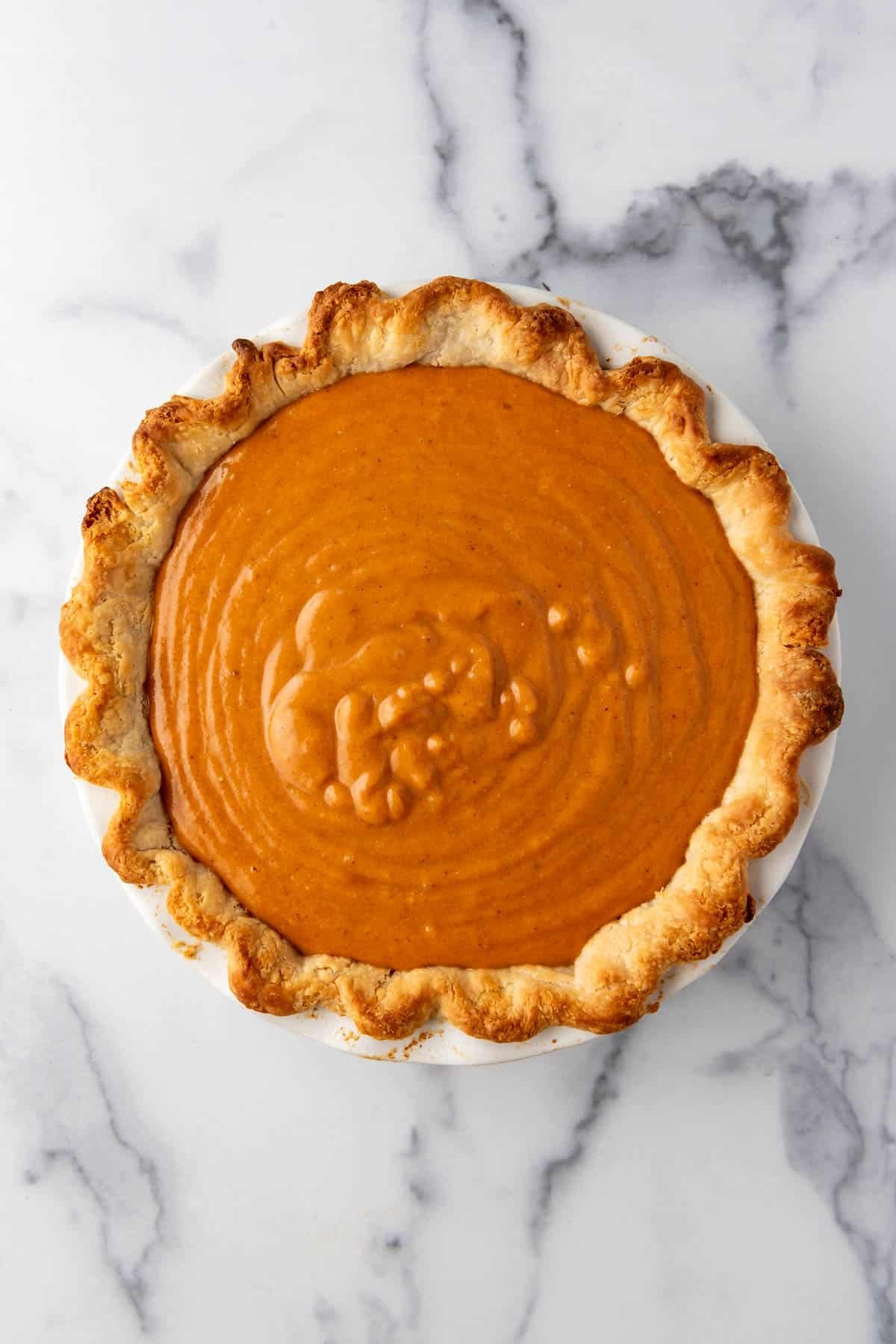 Sweet potato pie filling in a partially baked pie crust.