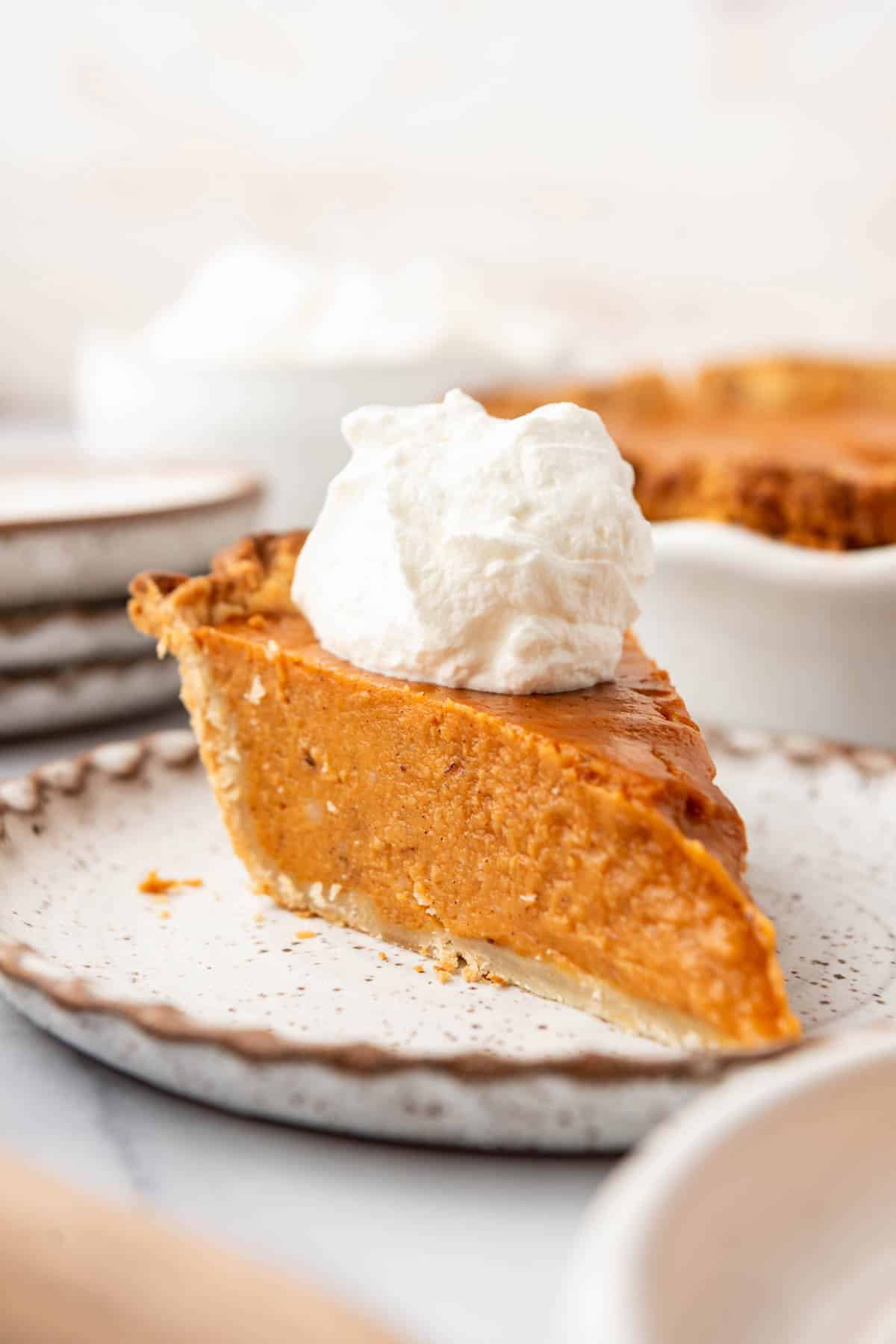 A slice of sweet potato pie on a plate.