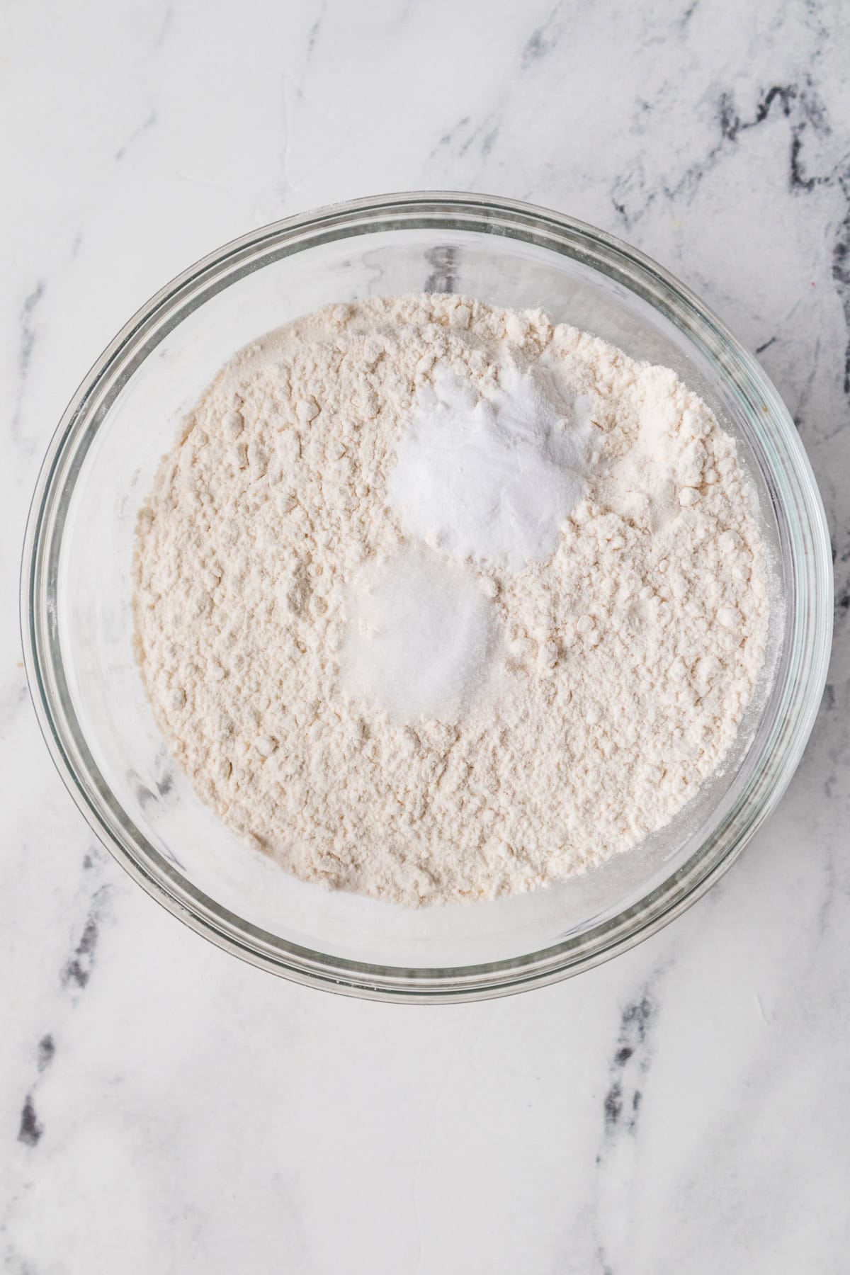 A bowl of flour, baking soda, and salt.
