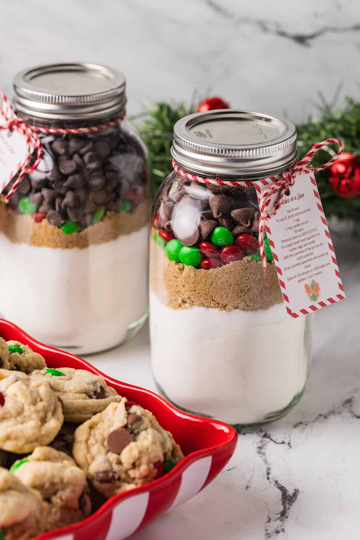 An image of two jars of cookie mix with holiday M&M's.