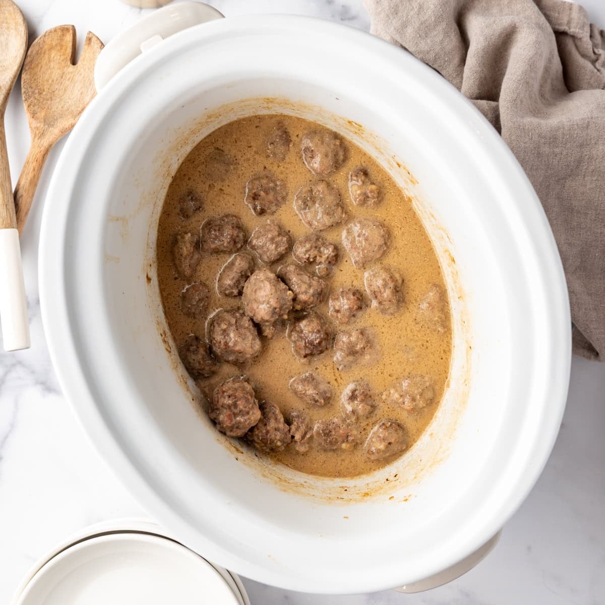 Slow cooker Swedish meatballs in creamy sauce served over egg noodles