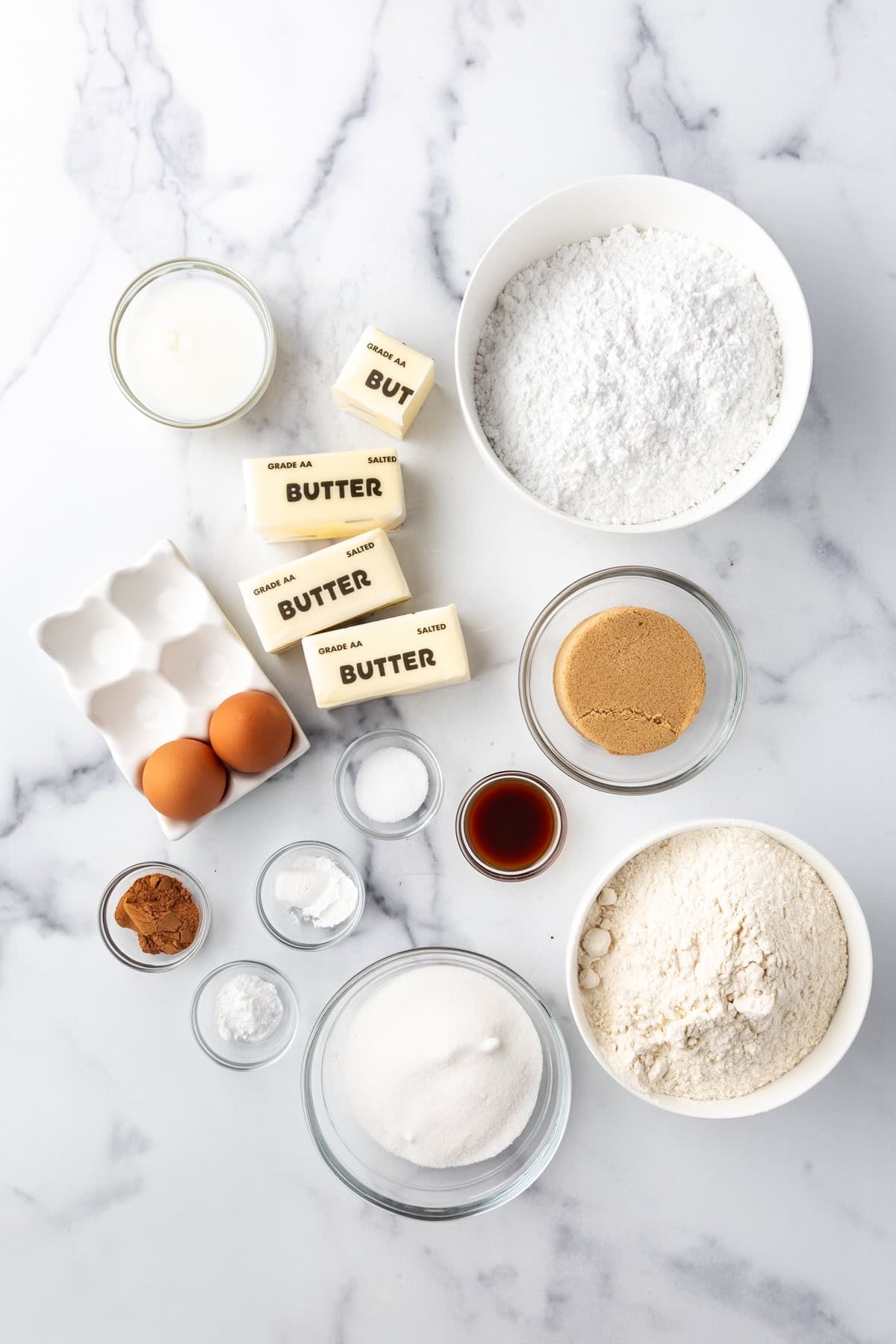Ingredients in separate bowls on a white surface.