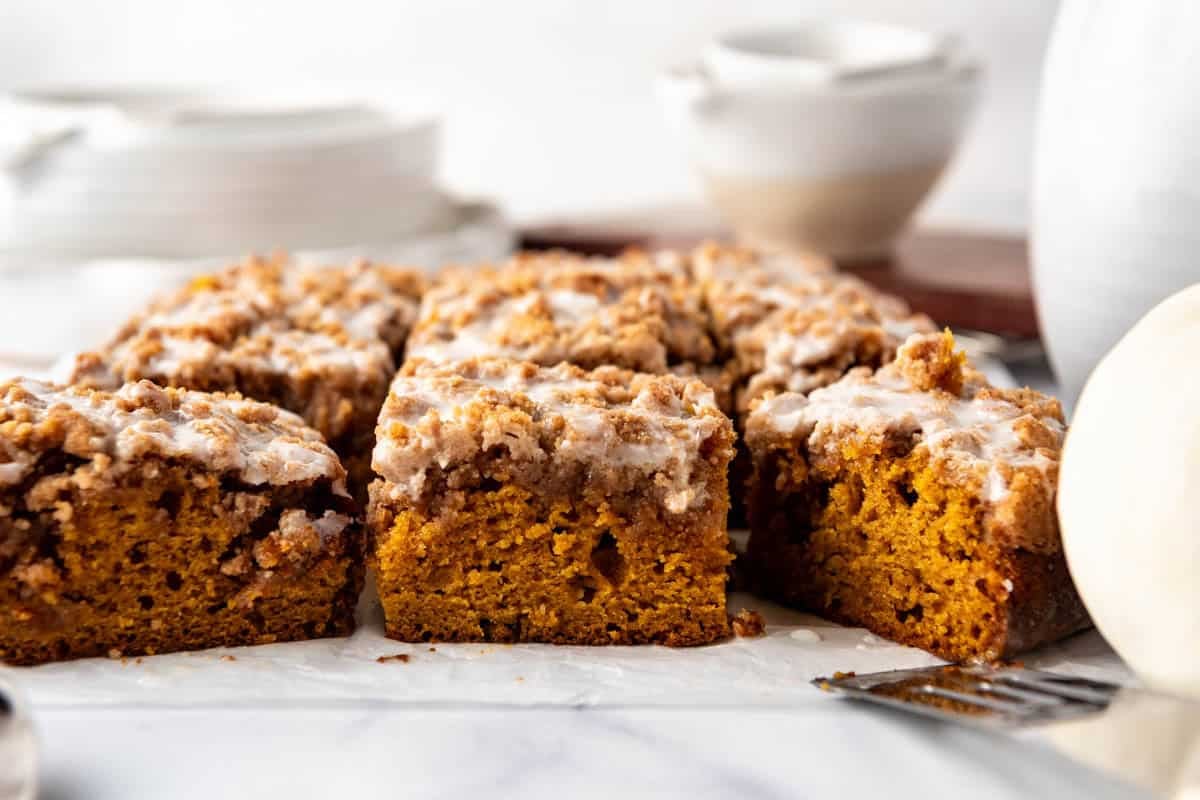 A side view of slices of moist pumpkin crumb cake.