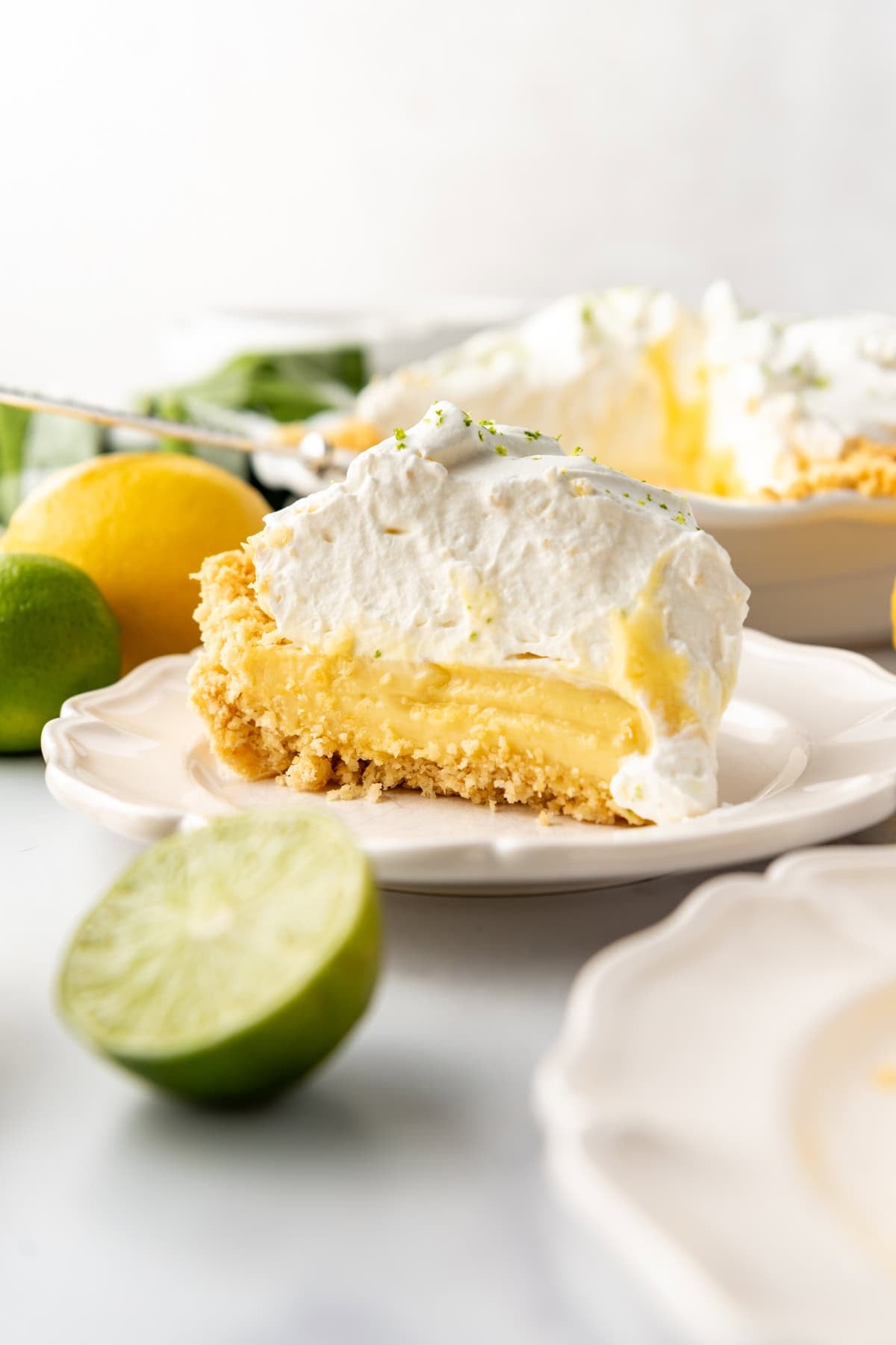 A slice of Atlantic Beach pie on a plate with half of a lime in front of it.