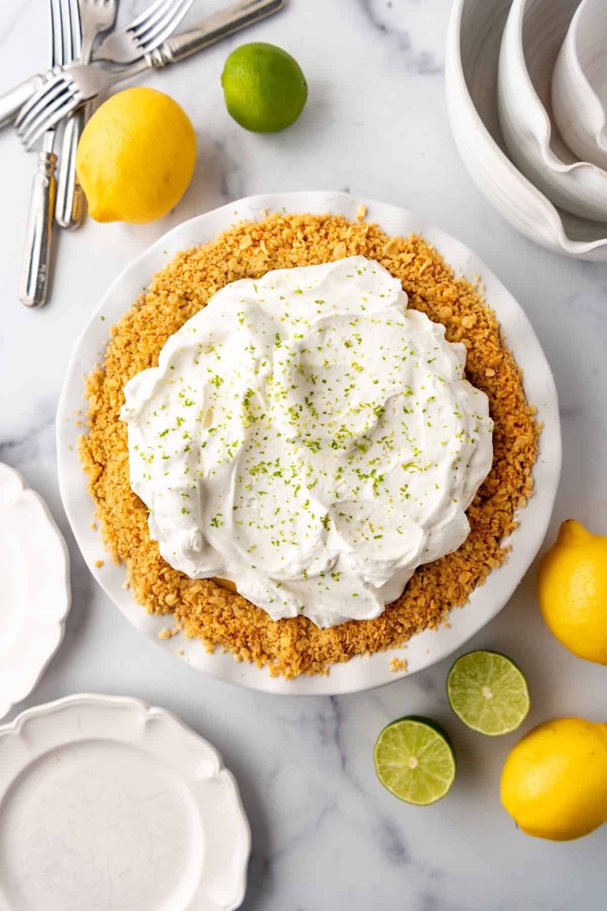 An overhead image of a finished Atlantic Beach pie surrounded by lemons and limes. - 7