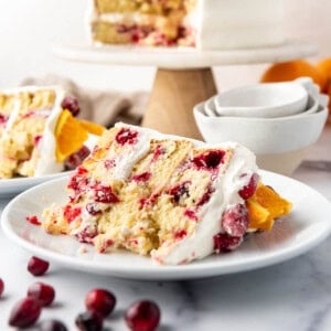 A slice of cranberry orange cake on a white plate.