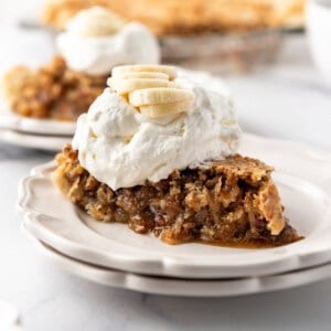 A slice of Kentucky sawdust pie on a plate stacked on another plate.