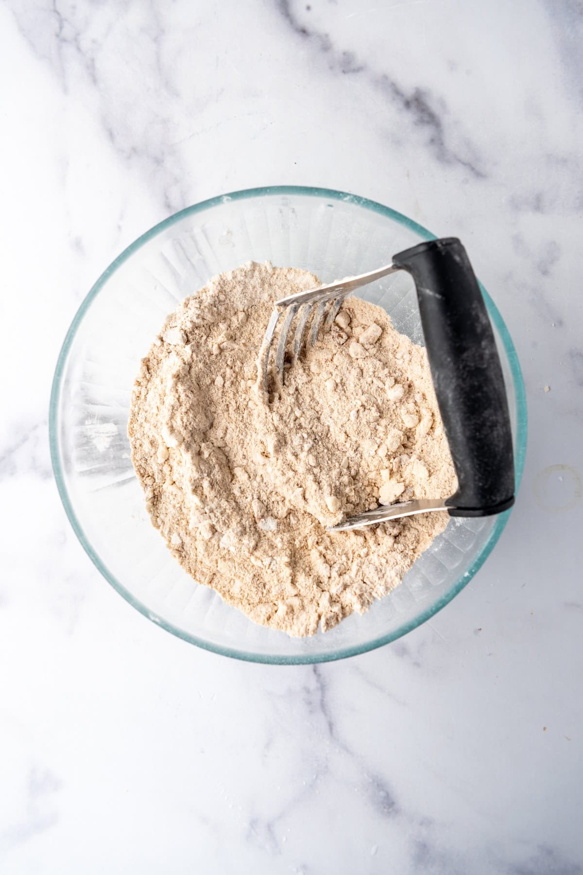 Cutting butter into flour and other dry ingredients for making shoofly pie.