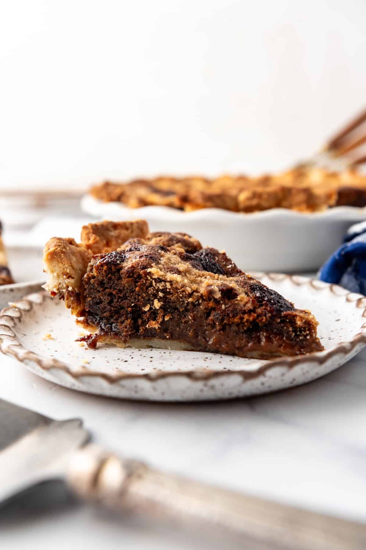 A slice of shoo fly pie on a plate.