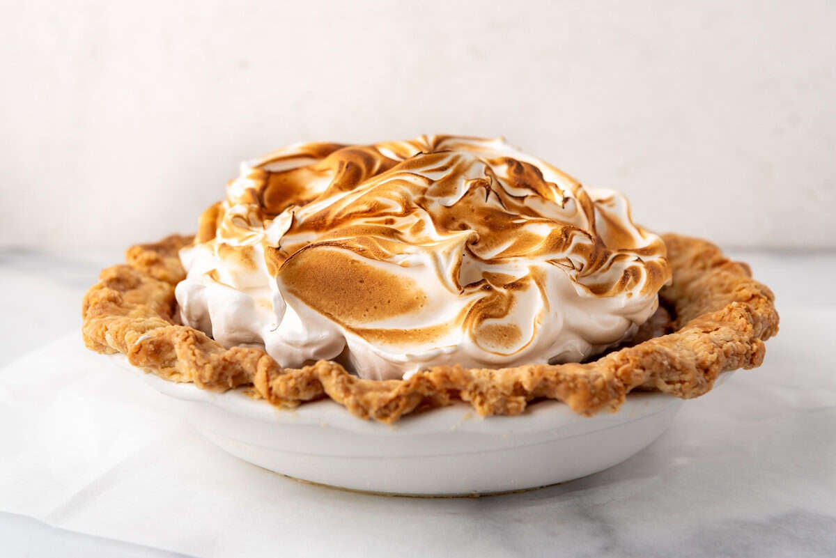 An image of a sweet potato pie topped with toasted marshmallow meringue.