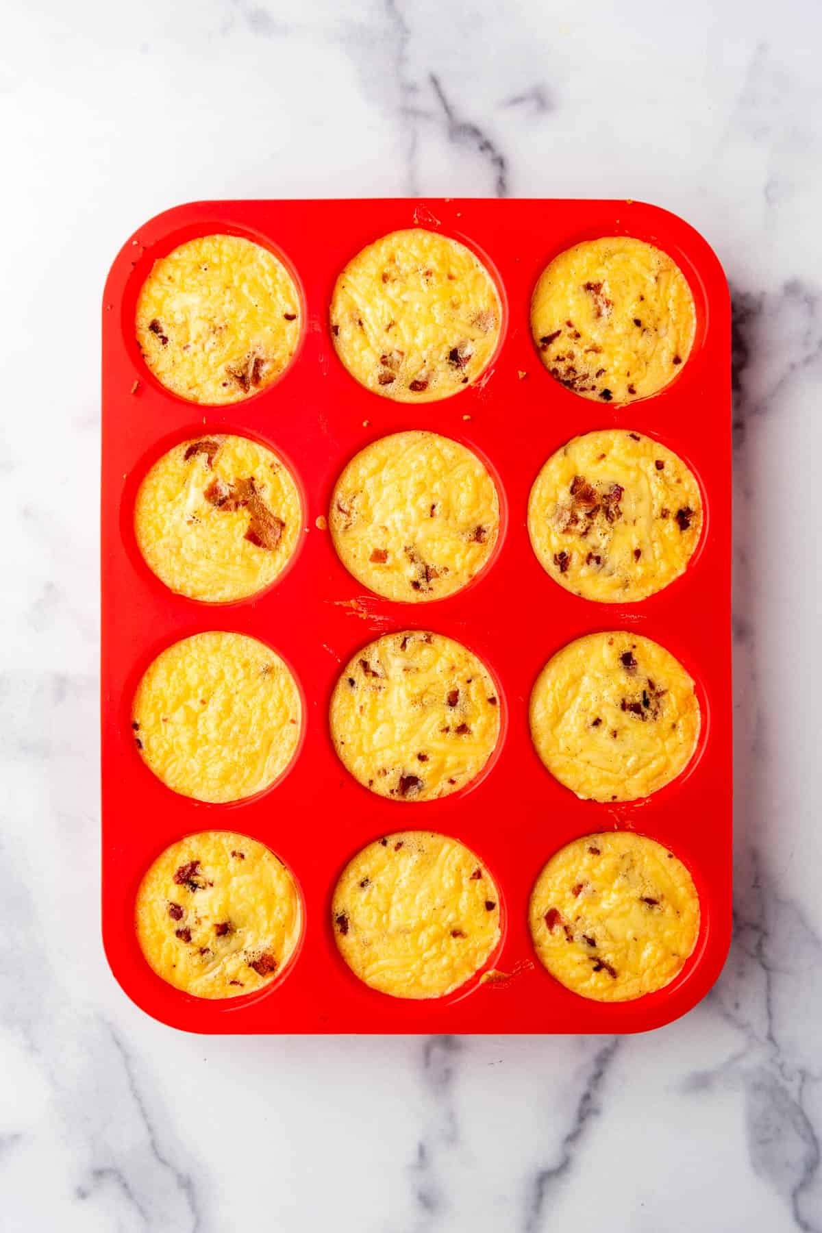 Baked egg bites in a silicon muffin mold.