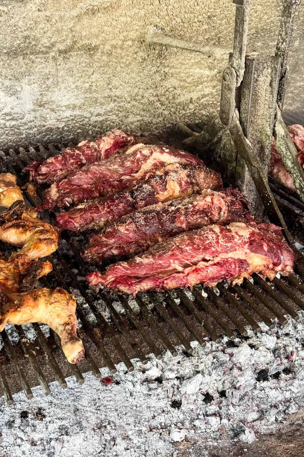 Meat being grilled over charcoal in Argentina.