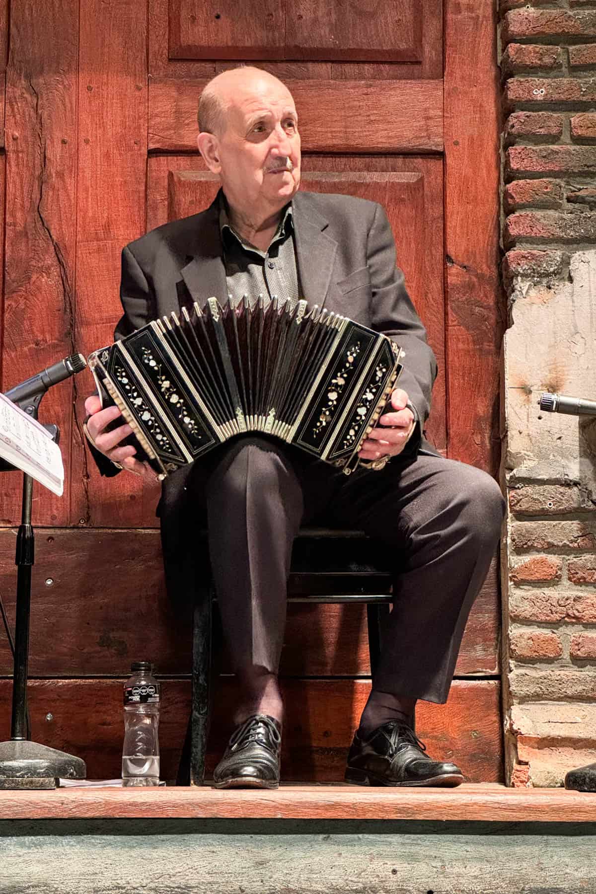Accordion player on stage in Buenos Aires at a tango show.