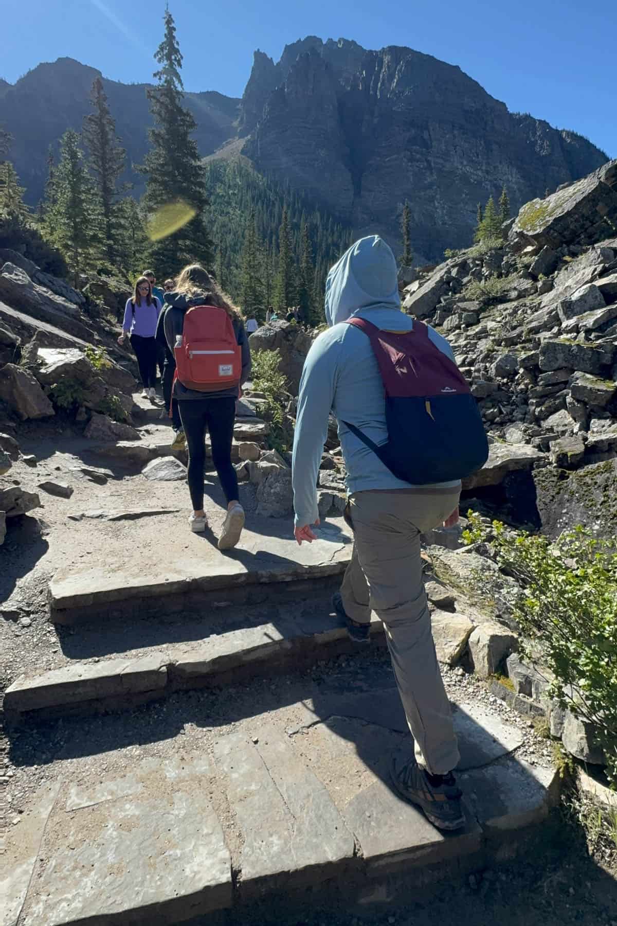 People hiking up stone steps.