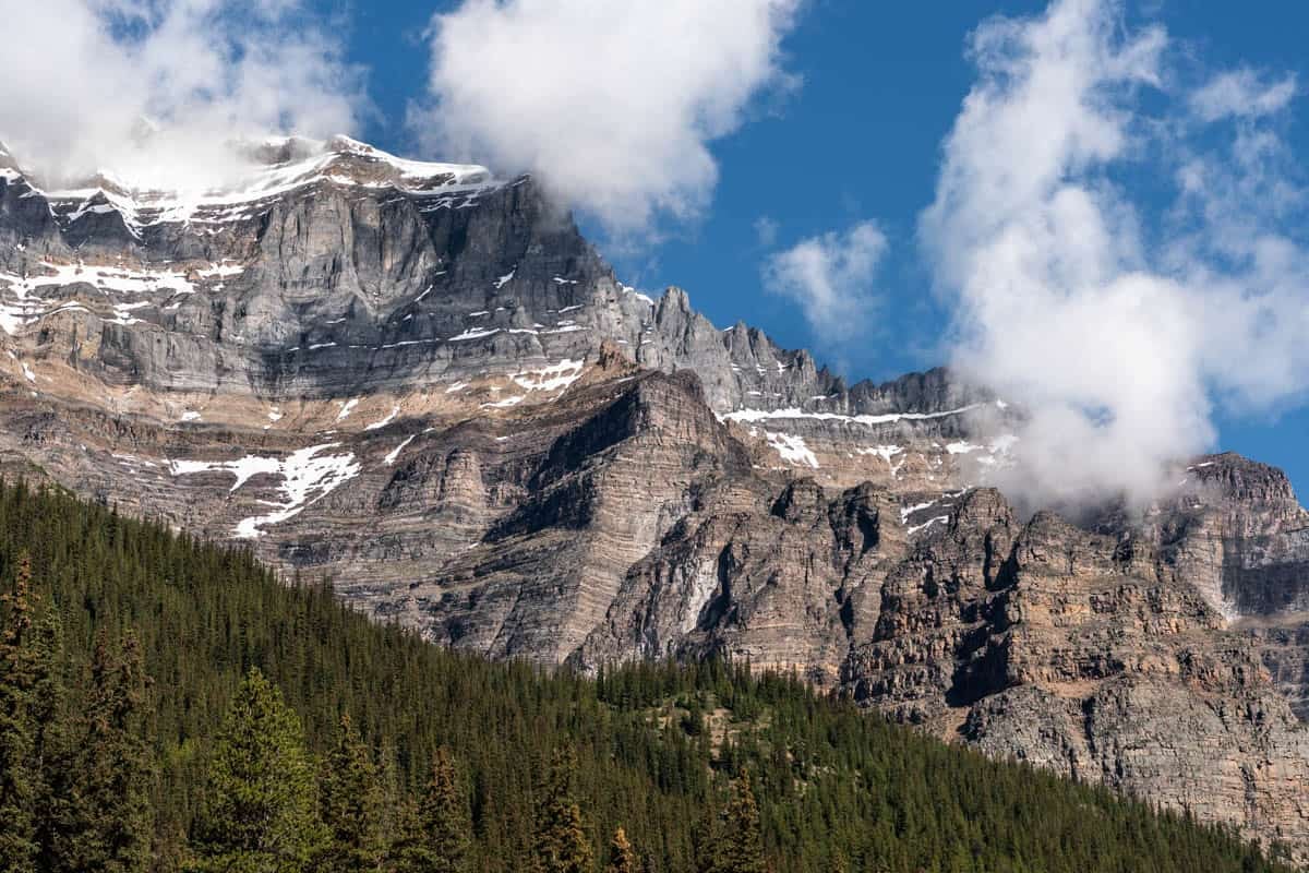 An image of a tall rocky mountain range with snow on it.