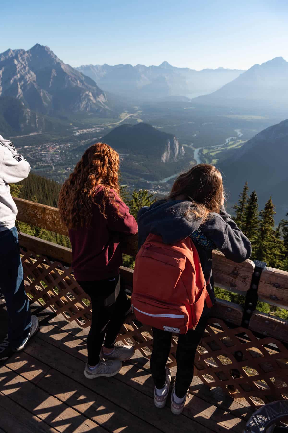 Two girls looking out at the view of Banff Town in Canada.