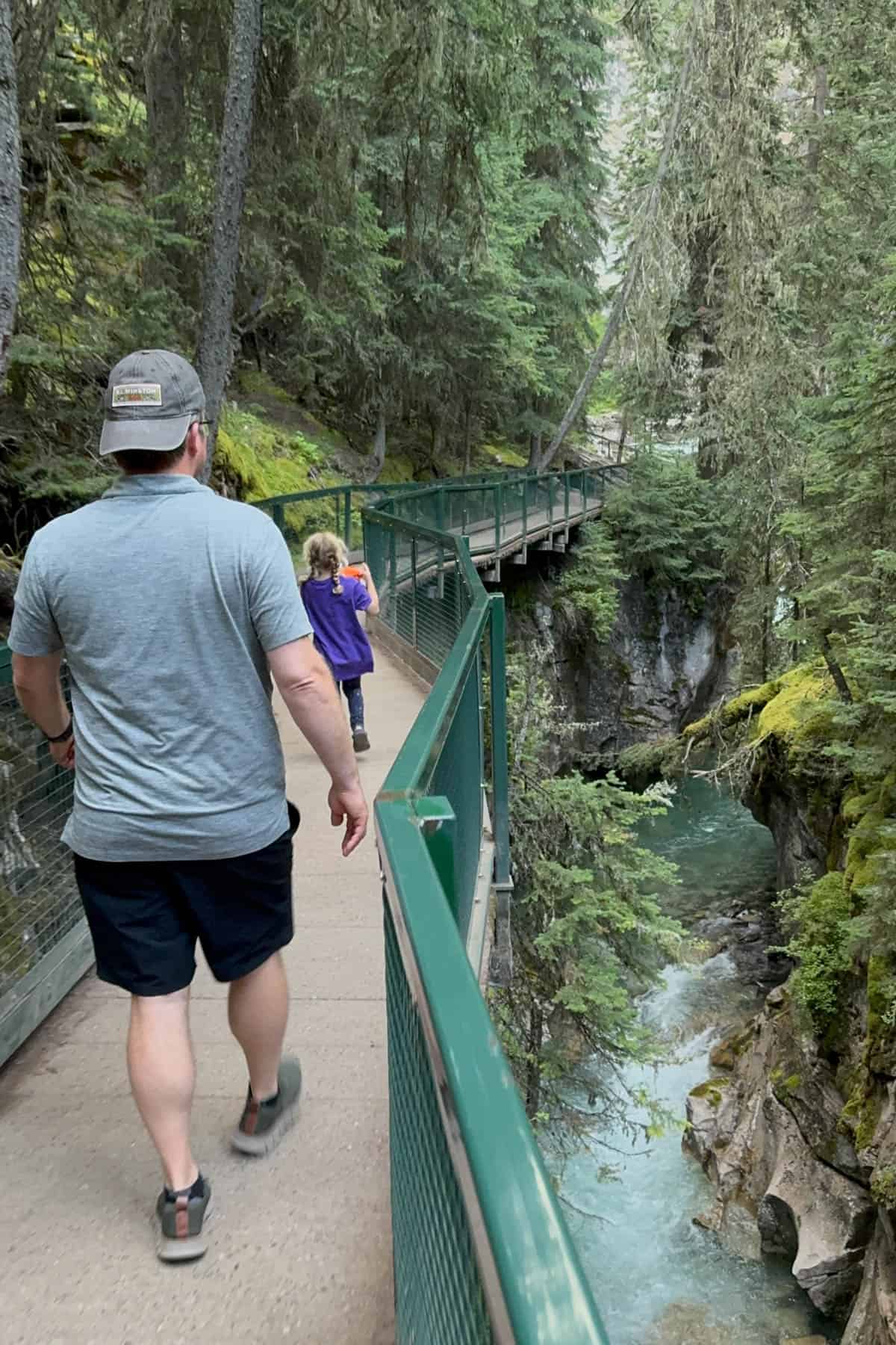 Walking along a paved trail in a narrow canyon.