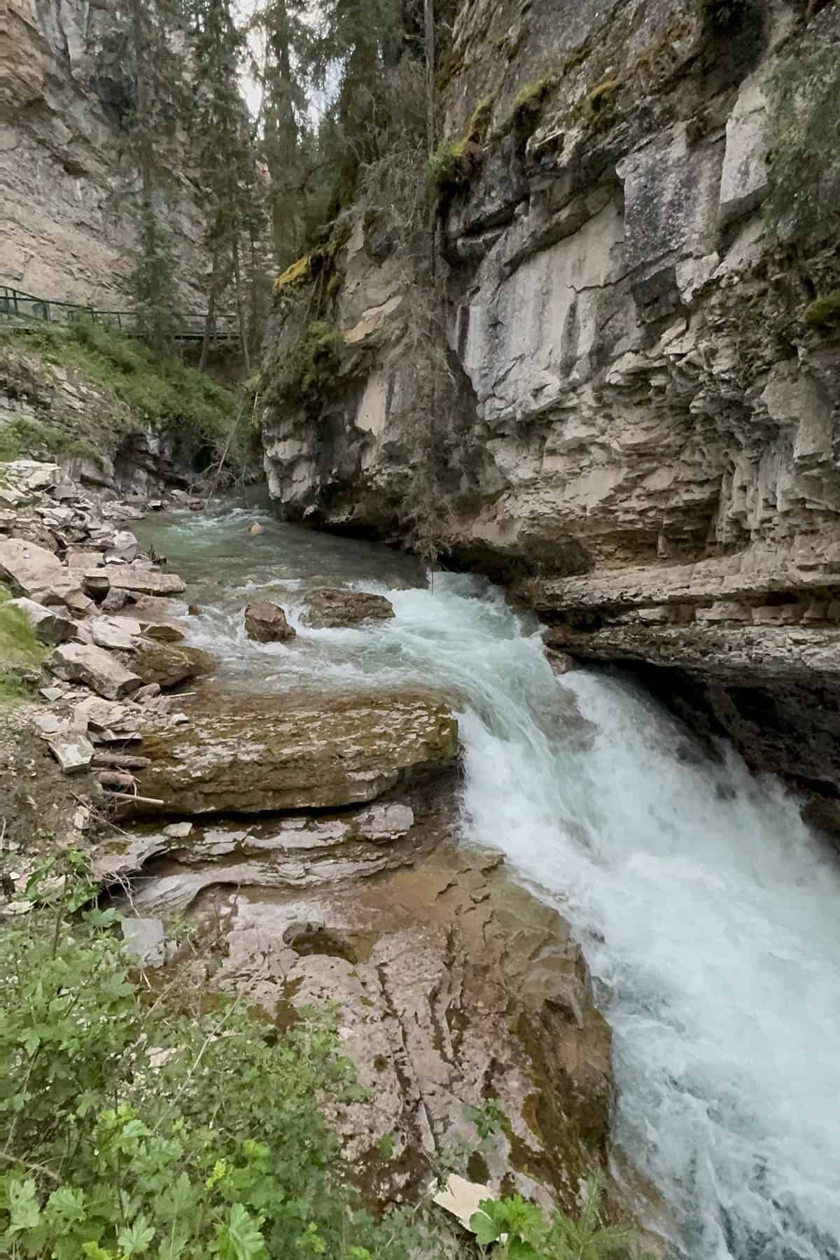 A river rushing through Johnson Canyon in Canada.