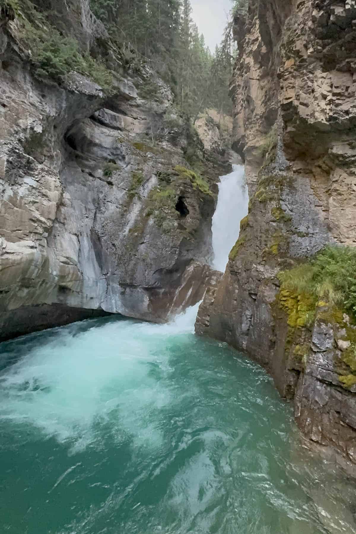 A waterfall with a pool below it.