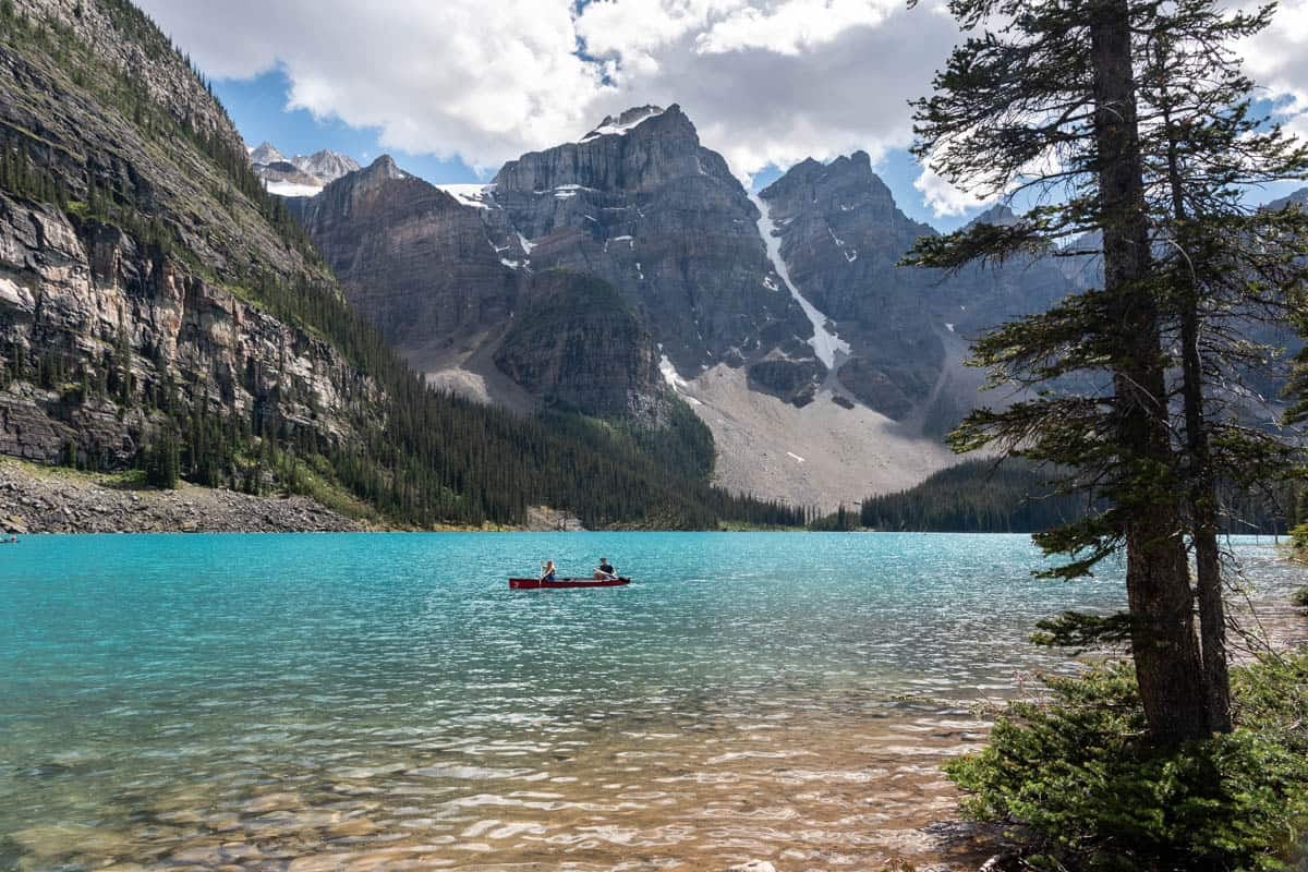 An image of a canoe on Moraine Lake in Canada in front of mountains.