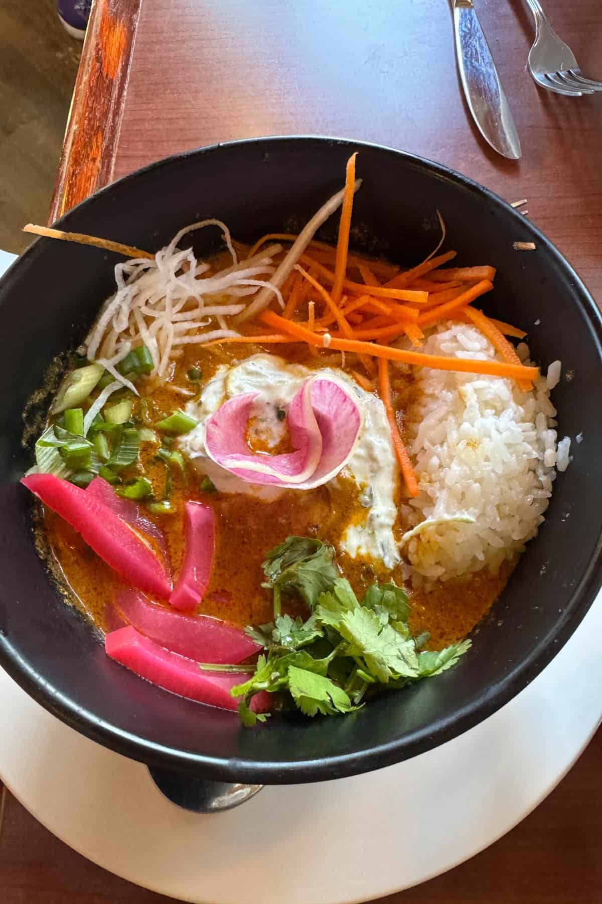 A Thai chicken rice bowl at a restaurant in Canada.